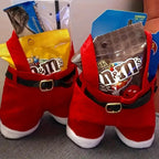 Red Santa pants with M&M's candy packages on a gray surface