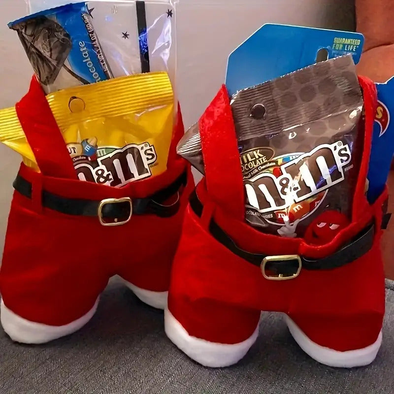 Red Santa pants with M&M's candy packages on a gray surface