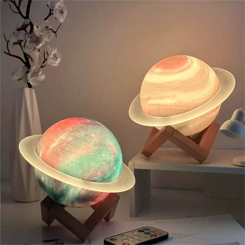 Two planet-shaped lamps on stands with a remote control on a table.