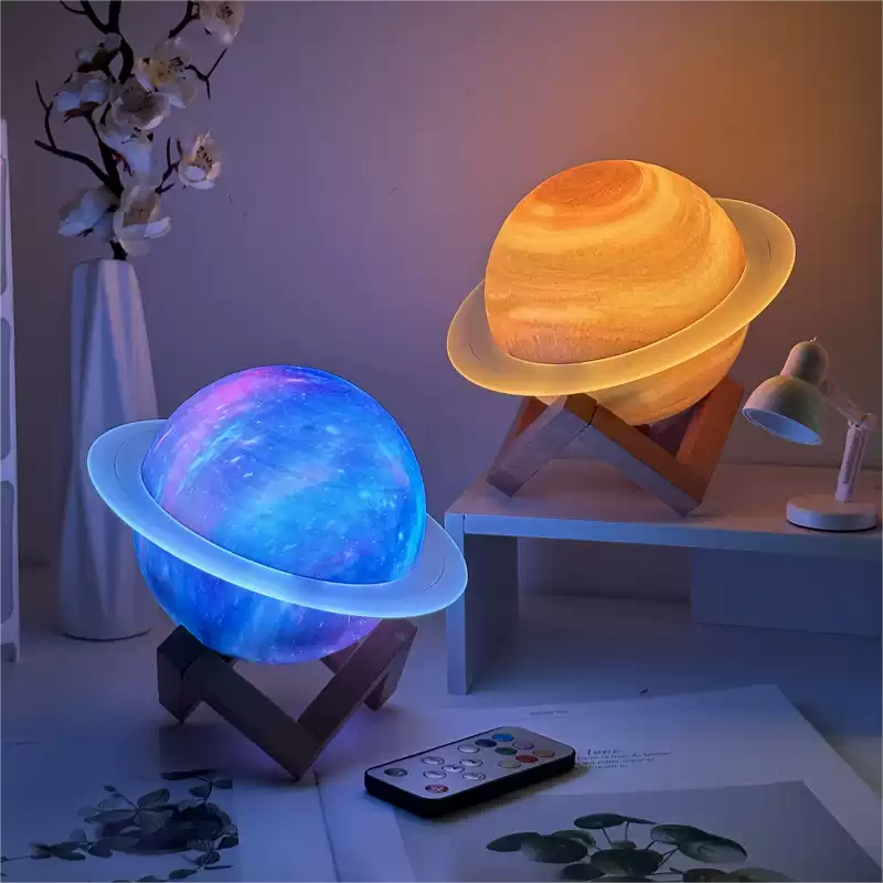 Two planet-shaped lamps on stands with a remote control on a table.
