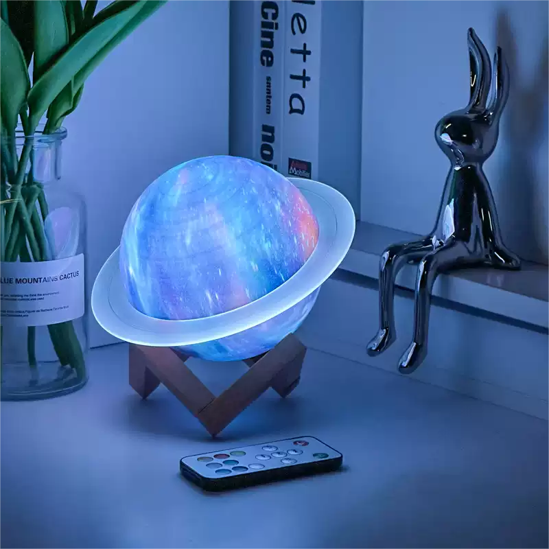 Colorful planet-shaped lamp on a stand with a remote control on a shelf.
