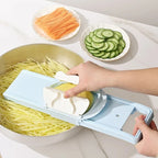 Person using a vegetable chopper to slice vegetables on a kitchen counter.
