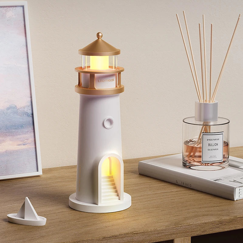 Lighthouse-shaped night light on a wooden surface with a diffuser bottle and book in the background.
