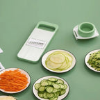 Green vegetable chopper with sliced vegetables on a green background
