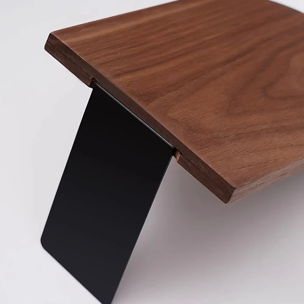 Wooden table with a black metal leg on a white background