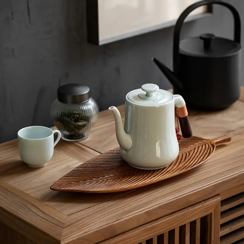 Tea set with a teapot and cup on a wooden surface