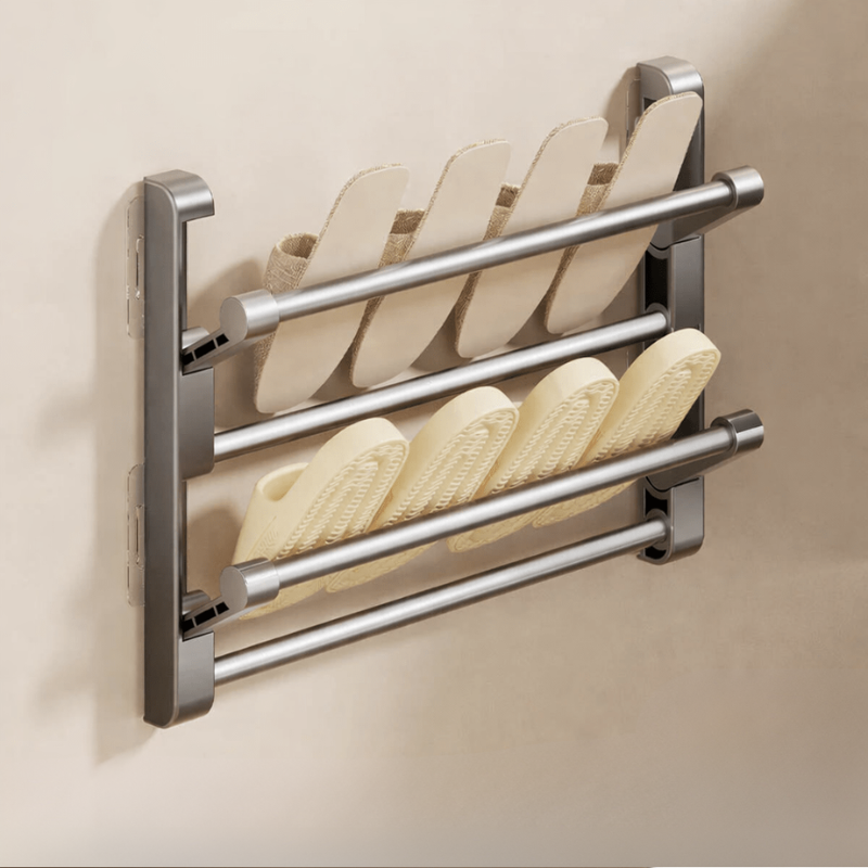 Wall-mounted shoe rack with four pairs of shoes on a beige background
