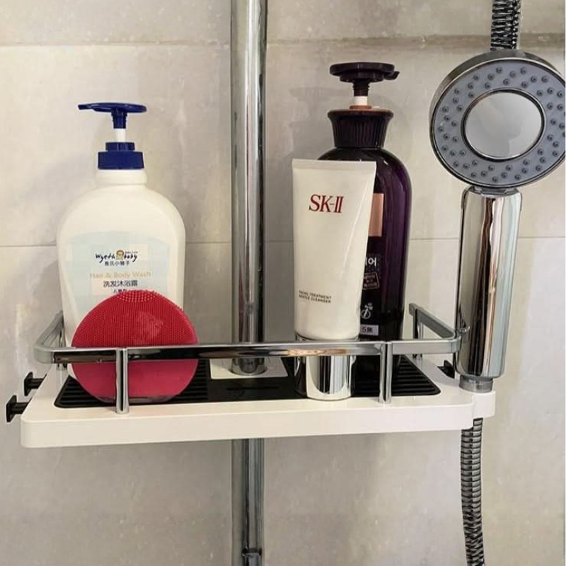 Shower caddy with various toiletries on a tiled shower wall.