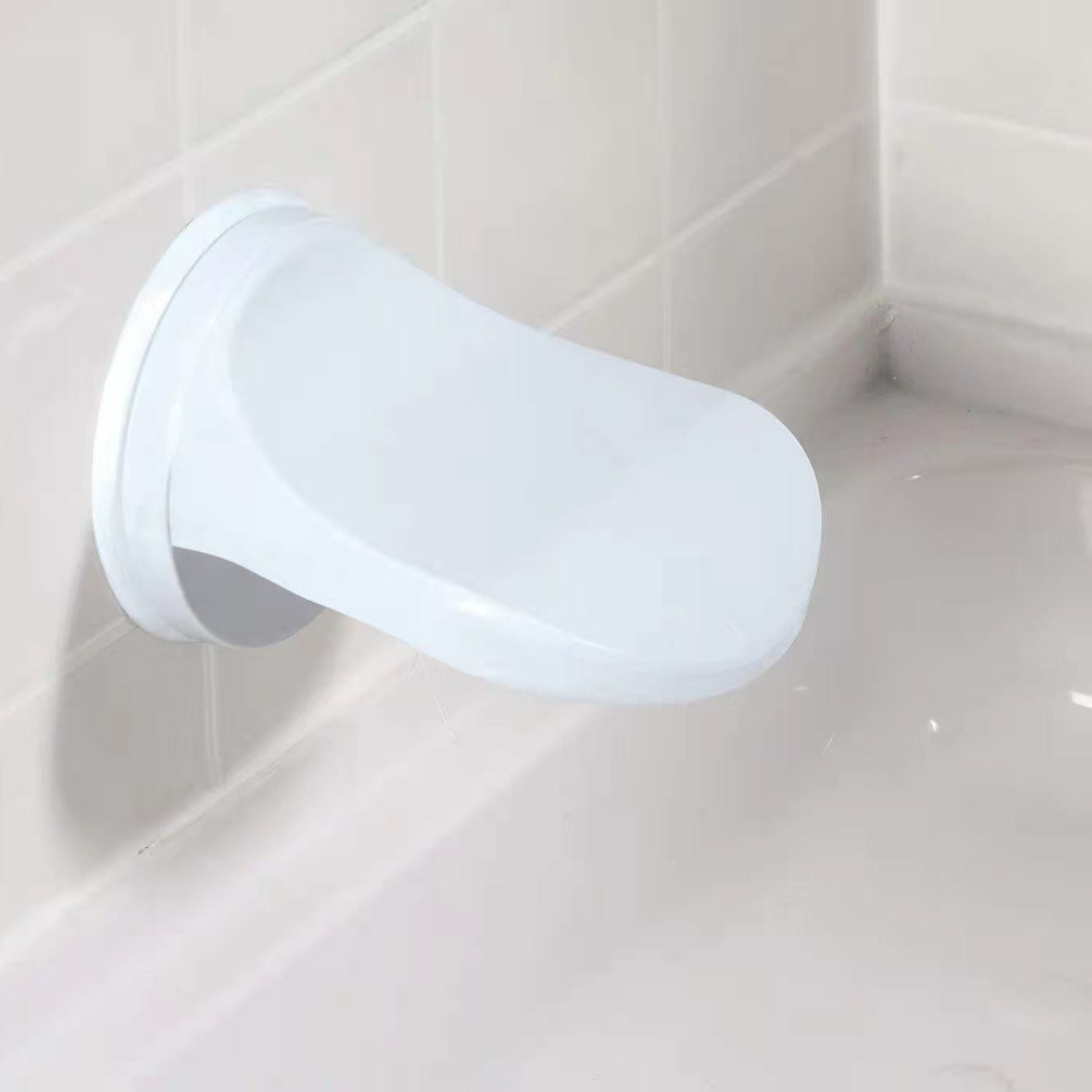 White shower head mounted on a tiled wall