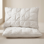 Two white quilted pillows on a neutral background