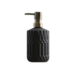 Black textured soap dispenser with metallic pump on a white background