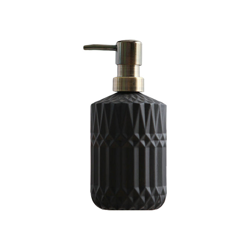 Black textured soap dispenser with metallic pump on a white background