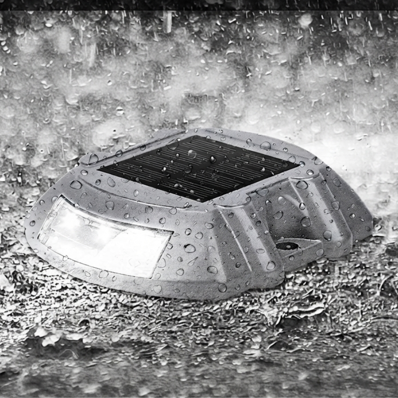 Solar-powered outdoor light fixture on a wet pavement