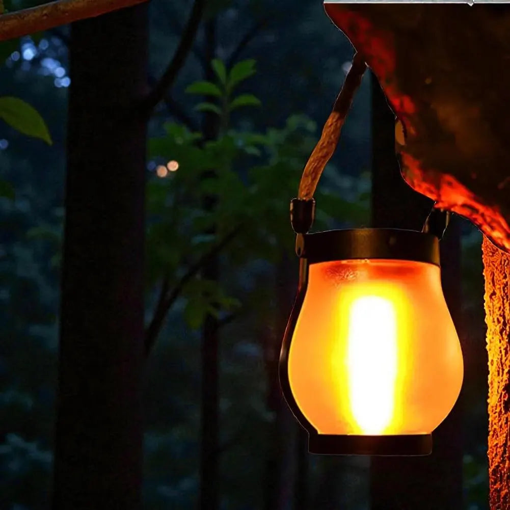 Solar lantern hanging outdoors with a dark forest background
