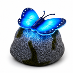 Blue butterfly light on a textured stone base with a white background