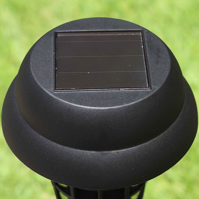 Black solar-powered outdoor light on a grass background