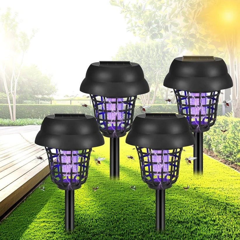 Four solar-powered outdoor mosquito lamps on grass with a garden background.