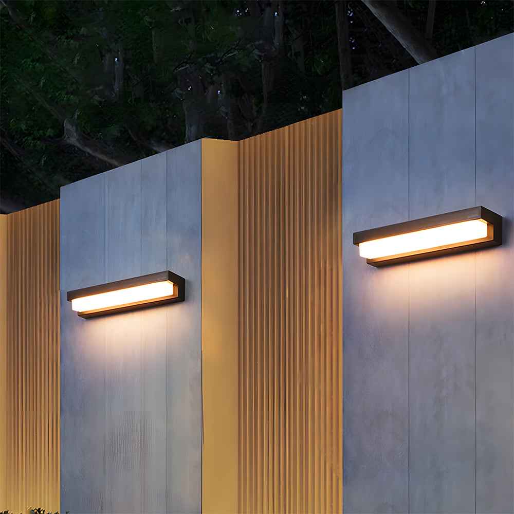 Two modern outdoor wall lights on a building facade at night.