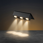 Black outdoor light fixture emitting light on a dark background