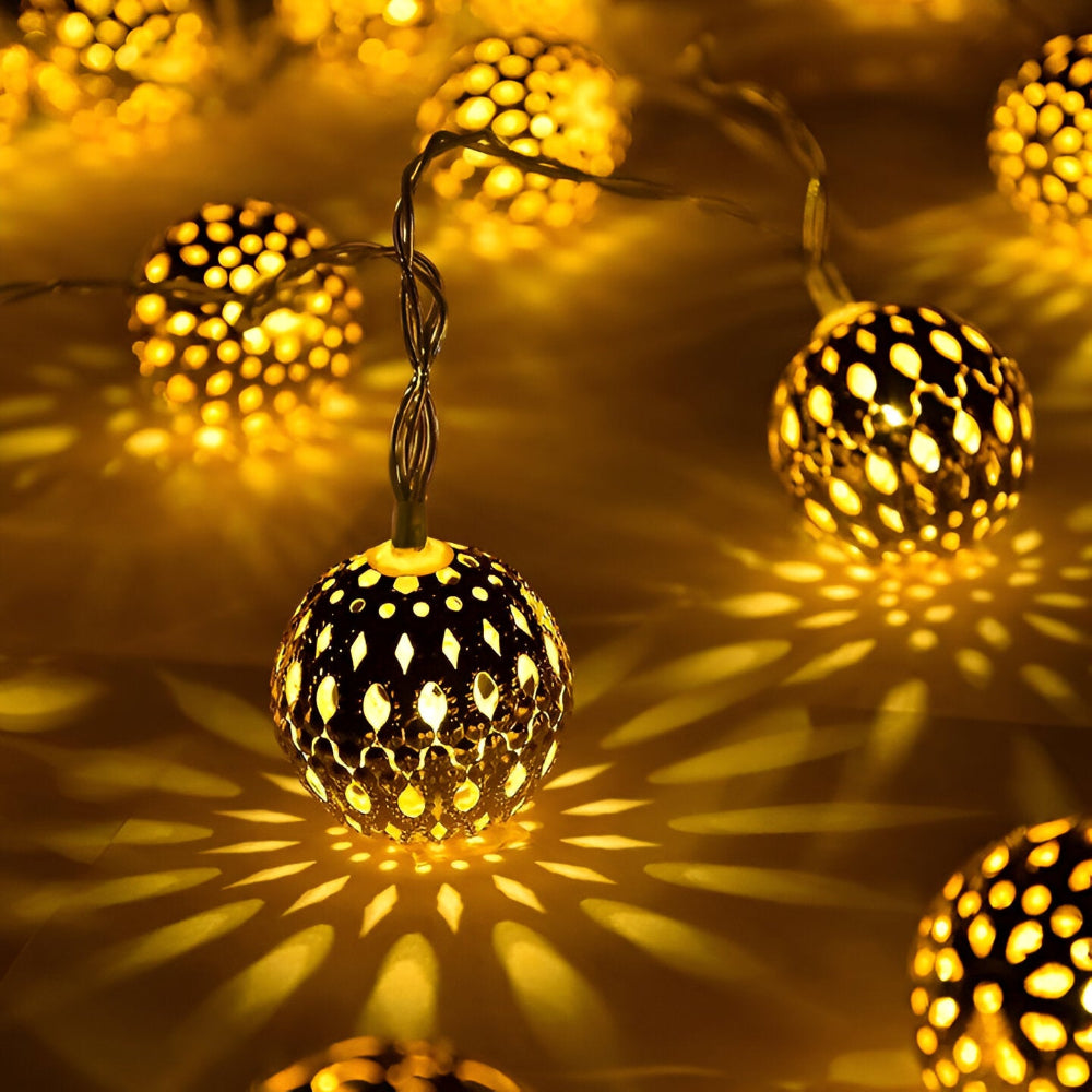 String of decorative lights with honeycomb pattern casting shadows on a surface