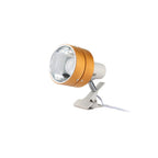 A clip-on spotlight with a metallic gold-colored outer body, a clear reflective lens, and a silver metal clip base with a white power cord, shown against a plain white background.