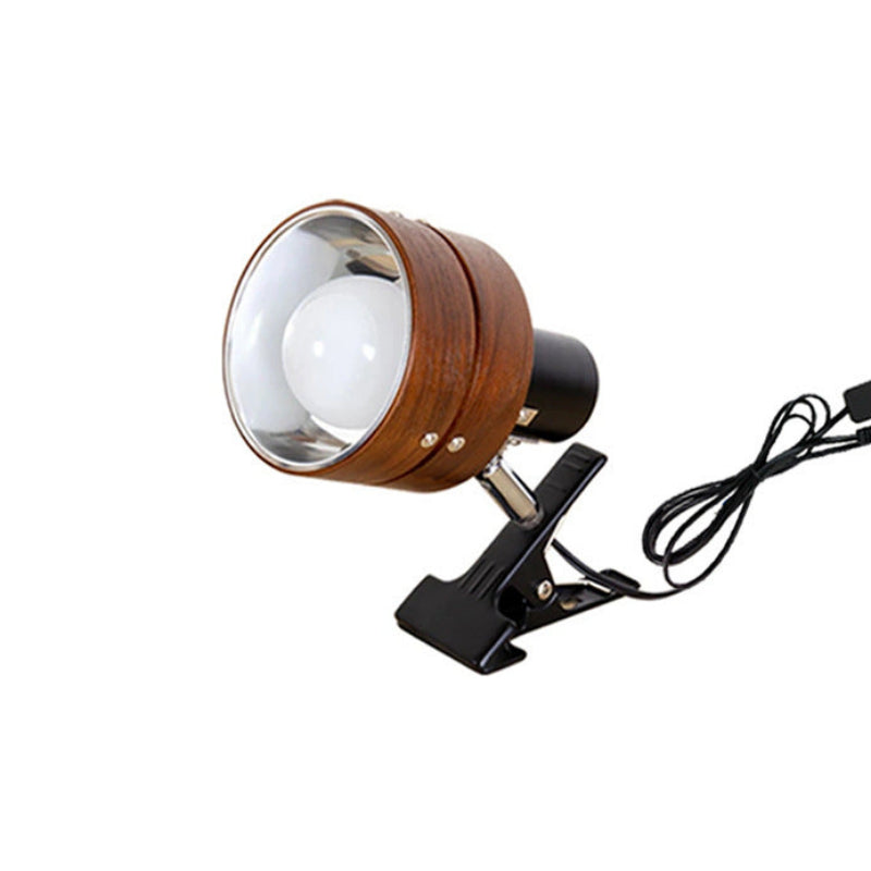 A clip-on spotlight lamp with a round wooden-grain finish, a clear glass lens, and a black clip base holding a white bulb, shown on a plain white background.