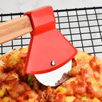 Red pizza cutter slicing into a pizza on a cooling rack.