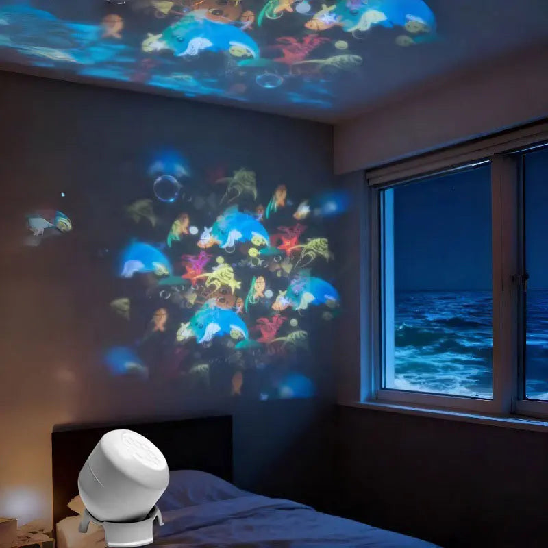 Room with colorful fish projections on ceiling and walls, next to a window with ocean view.