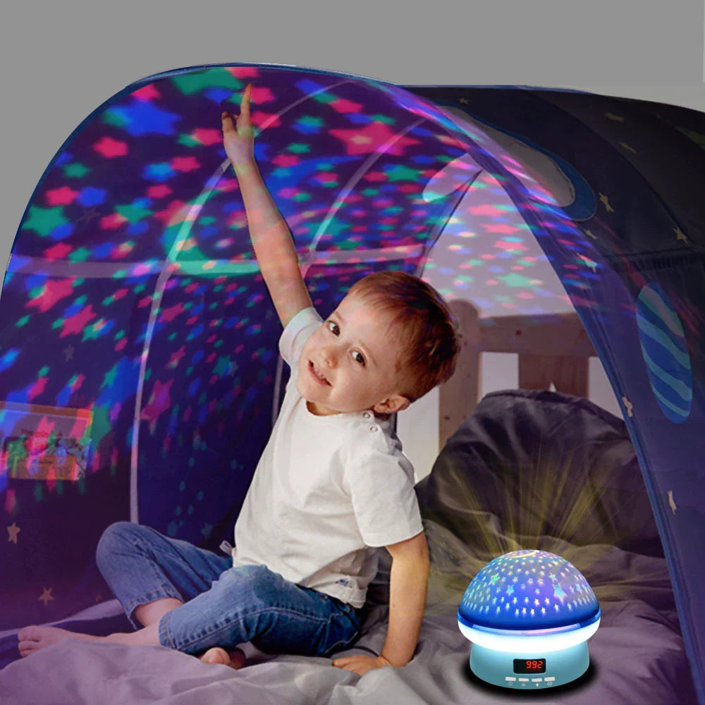 Child playing with a colorful light projector in a tent