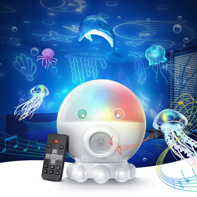 A white octopus-shaped LED night light with a rainbow color-changing globe head, shown with a black remote control against an underwater scene background featuring a dolphin, jellyfish, and sea plants.