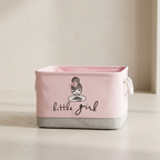 Pink storage basket with 'little girl' text and design on a neutral background