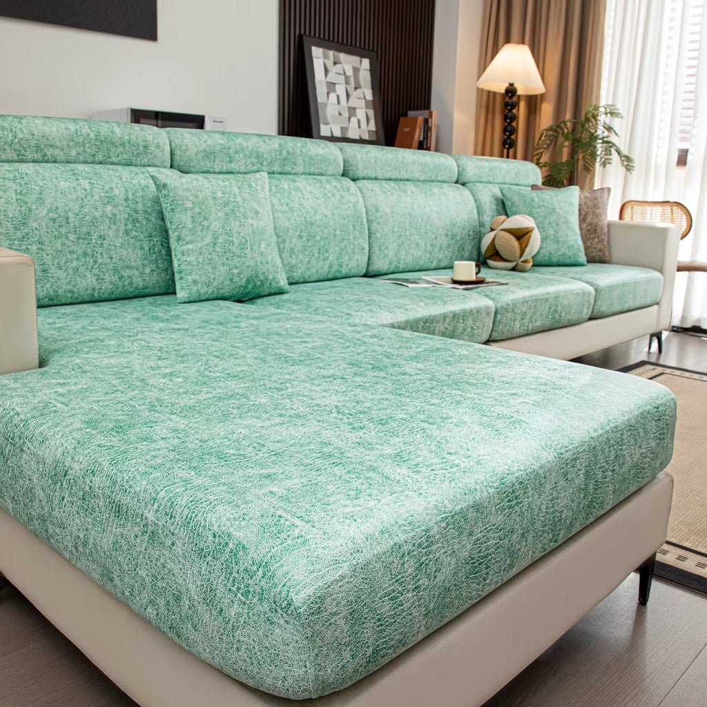 Green sectional sofa in a living room setting with decor elements.