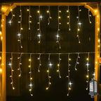 String lights hanging against a dark background with a power adapter on a wooden frame.