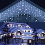 House decorated with string lights against a snowy background