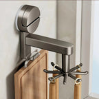 Wall-mounted coat rack with hooks and a cutting board on a neutral background