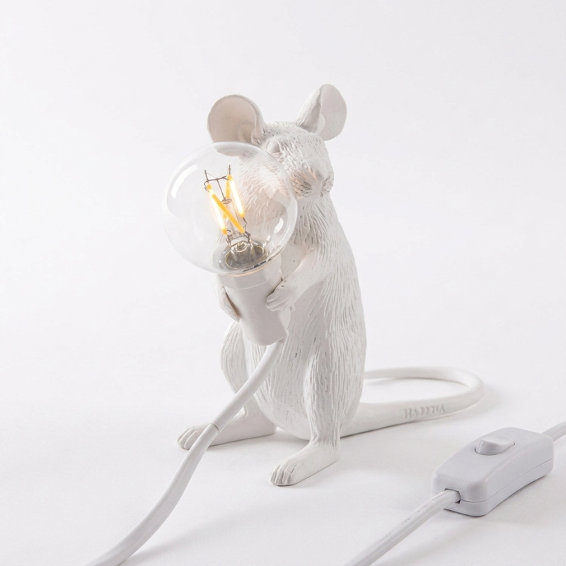 White mouse-shaped lamp with a light bulb inside on a white background