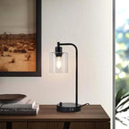 Modern black desk lamp on a wooden surface with a blurred background