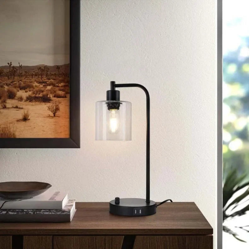 Modern black desk lamp on a wooden surface with a blurred background