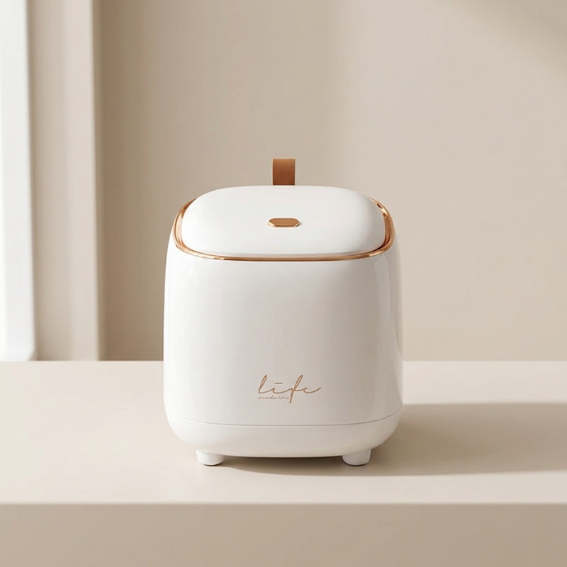 White humidifier with gold accents on a beige surface