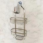 Shower caddy with multiple shelves attached to a shower head on a marble wall.