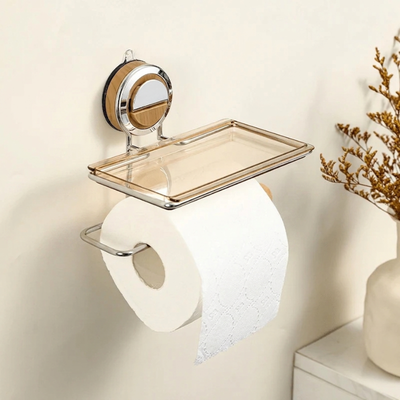 Wall-mounted toilet paper holder with a decorative tray on a neutral wall.