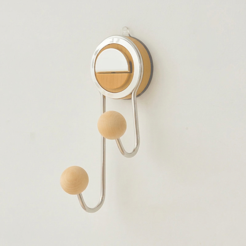 Wall-mounted hook with wooden knobs on a light gray background