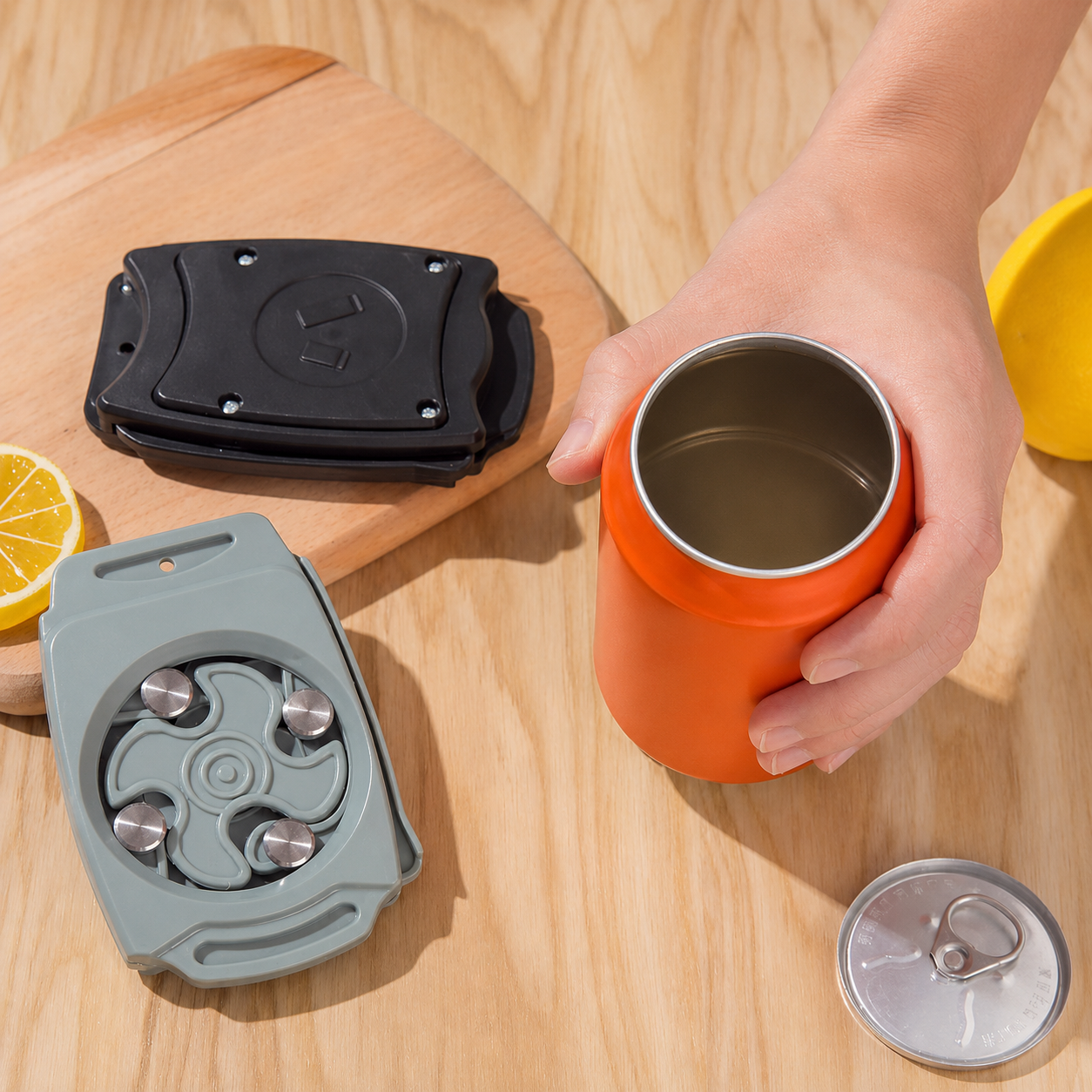 Orange mug with a black and gray lid on a wooden surface