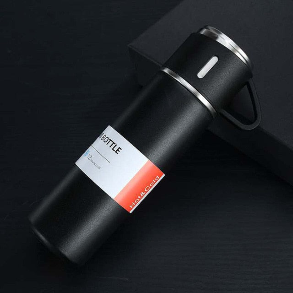 Black insulated bottle with a label on a dark background