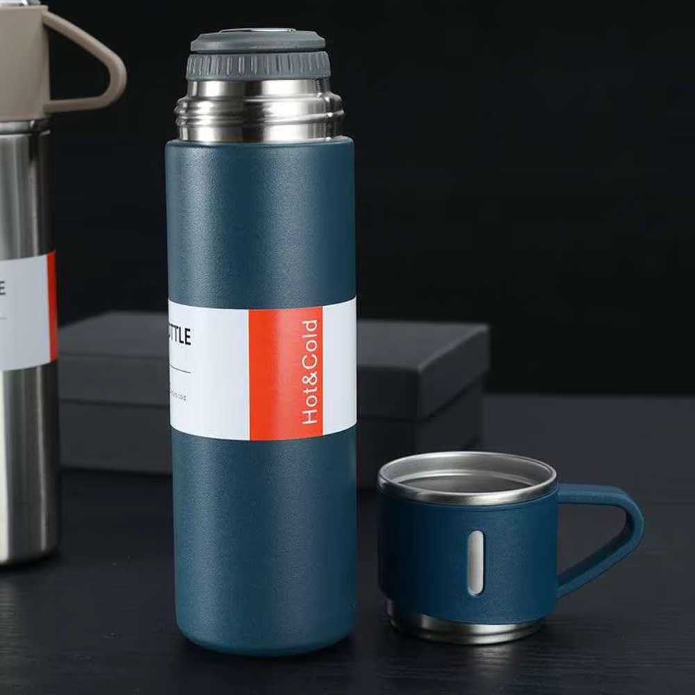 Blue thermos bottle with a matching mug on a dark surface