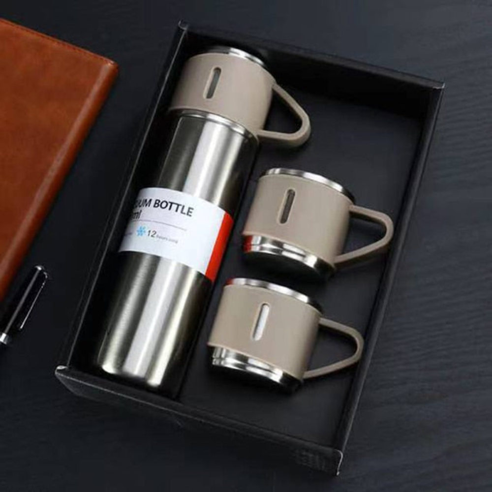 Stainless steel thermos set with two cups in a black box on a dark surface.