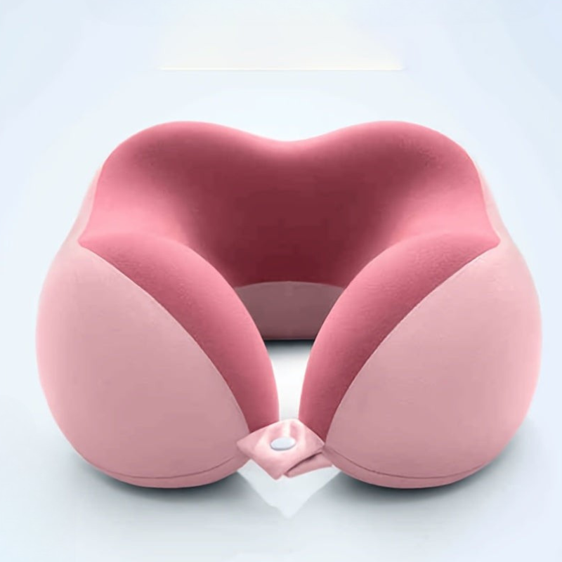 A pink contoured travel neck pillow with a matching adjustable strap, shown on a clean light gray background.