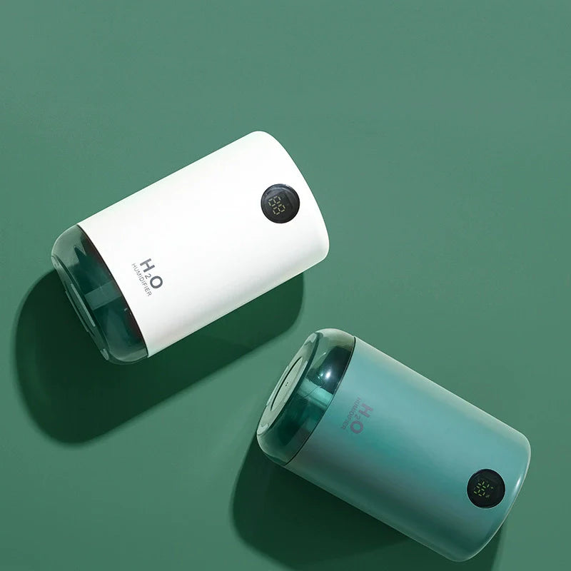 Two H2O bottles, one white and one teal, on a green background
