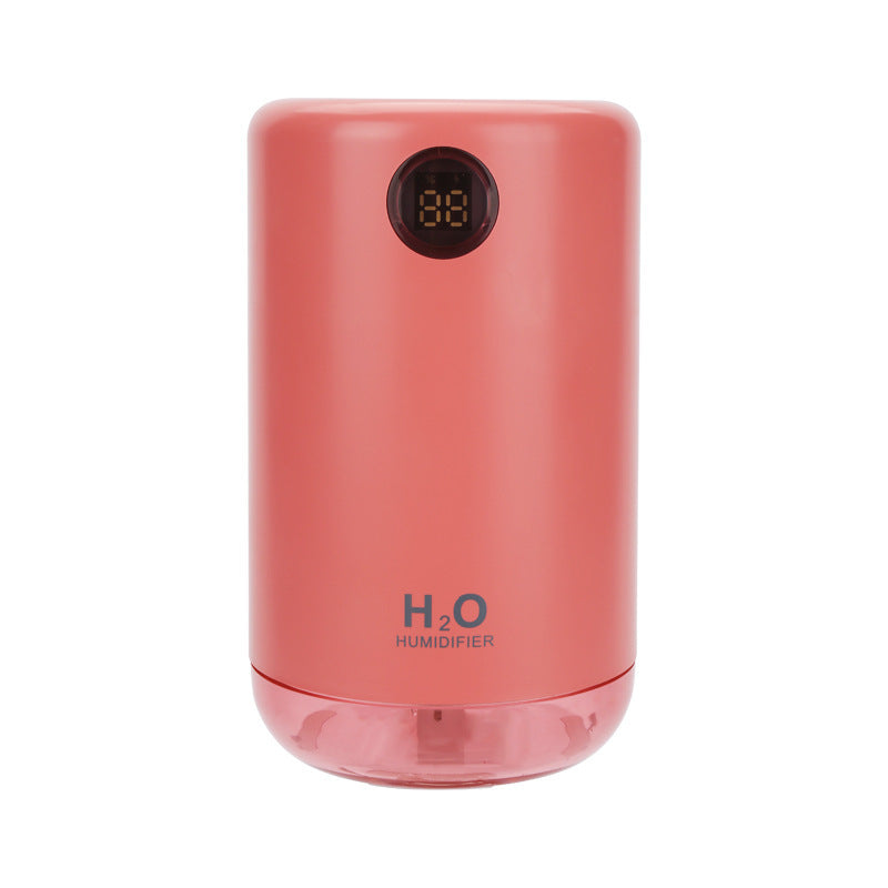 Pink humidifier with digital display on a white background