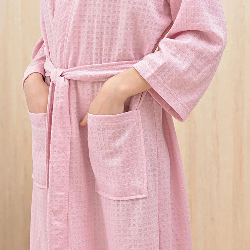 Pink textured robe with pockets on a beige background